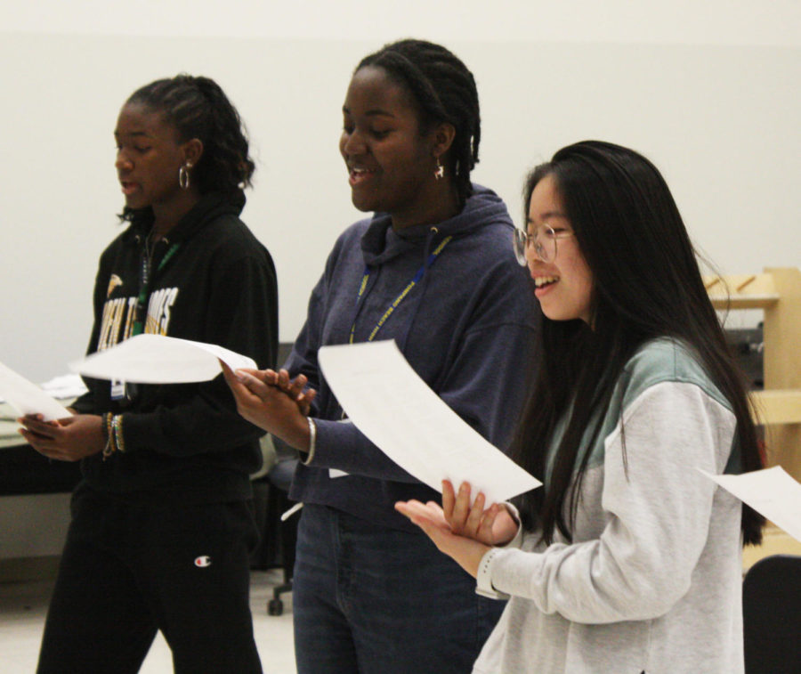 Sophomore Rebekah Christie, freshman Elyssa James, and sophomore Huiling Zhang sing at chorus practice after school on Dec. 6. The chorus performed Christmas carols at the Magnet Open House on Dec. 14. It was “very nerve-wracking,” James said. “But my mom said we sounded good, and everybody clapped for us.”