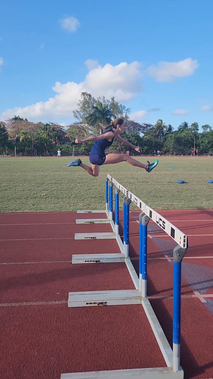 Senior Taylor McHugh jumps over the last hurdle in the 100m hurdle event at the Ft. Lauderdale meet on Feb. 22.