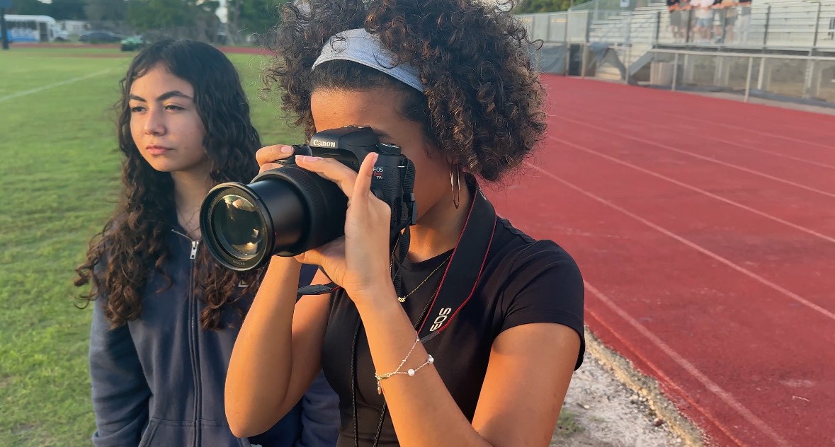 Film and Tech students take pictures at track meet.